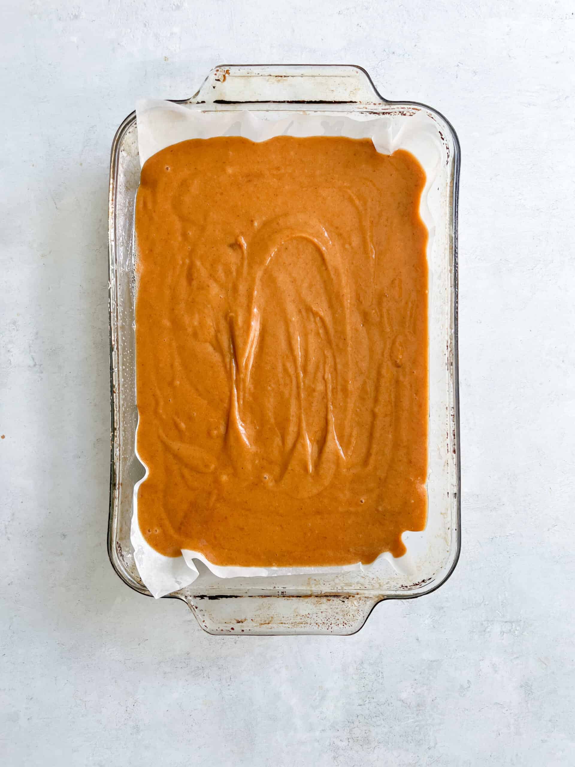 Rich caramel sauce layered in a glass baking dish, ready for baking or serving, featuring smooth texture and warm caramel hue—perfect for desserts like caramel pudding, flans, or decadently drizzled over cakes.