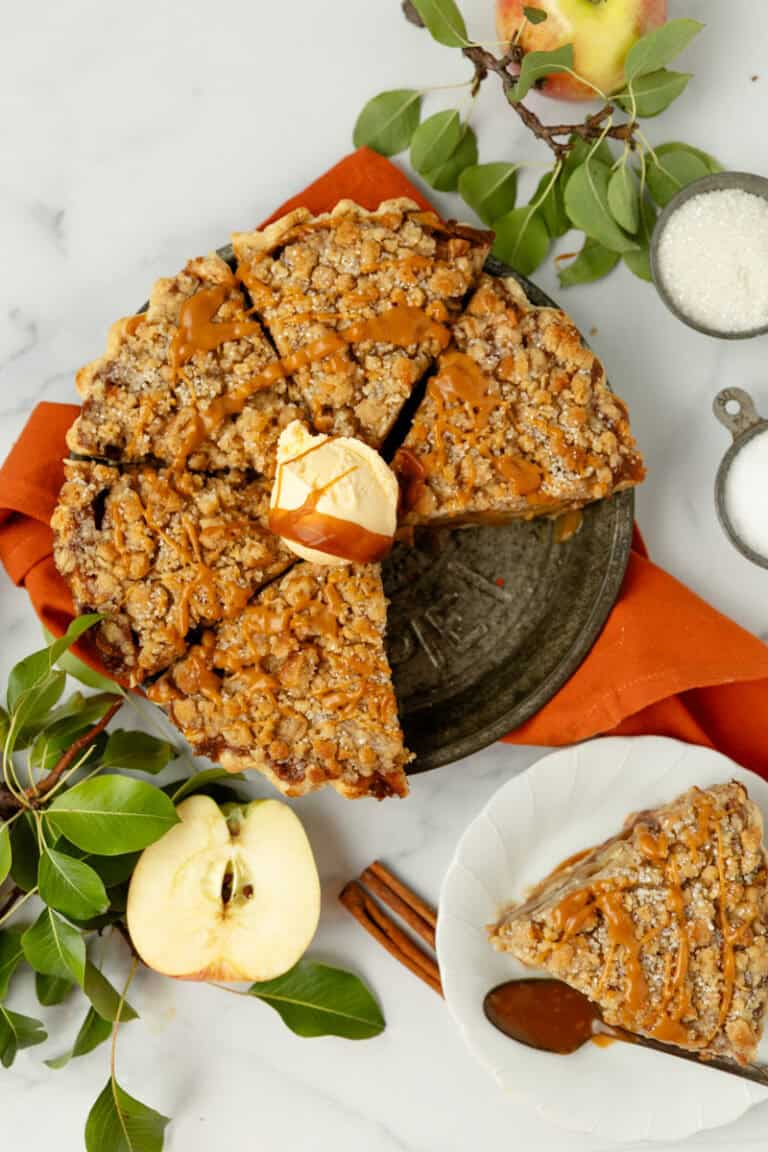Butterscotch apple crumble pie with caramel drizzle, served with vanilla ice cream. Perfect fall dessert with fresh apples, cinnamon, and buttery crumble topping. Ideal for holiday gatherings and cozy dessert moments.